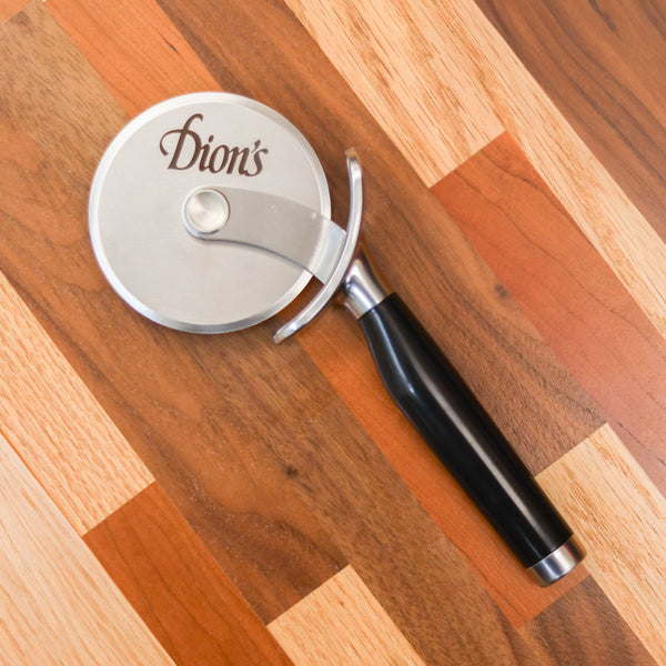 Dion's Fan Shop introduces The Chef Bundle on a wooden floor, perfect for grating cheese over your favorite homemade pizza.