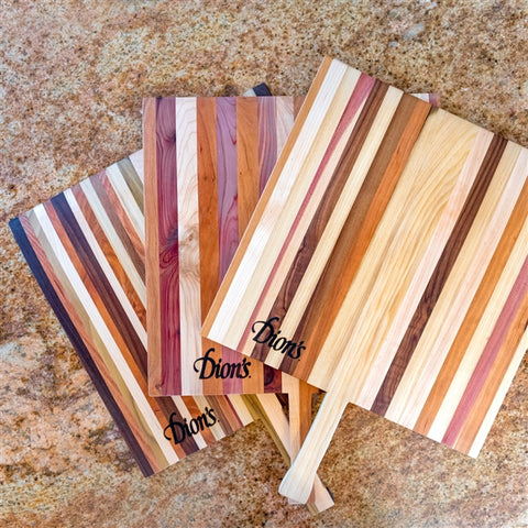 Each pizza board is unique and created using an assortment of woods including walnut, African mahogany, white maple, cherry, red oak, poplar, and cedar. 
