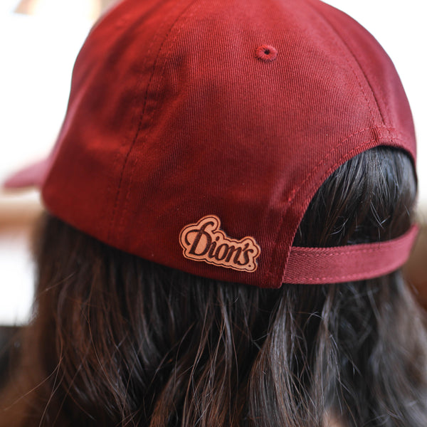 Person wearing a backward Ranch Cap from Dion's Fan Shop, with long dark hair visible beneath.