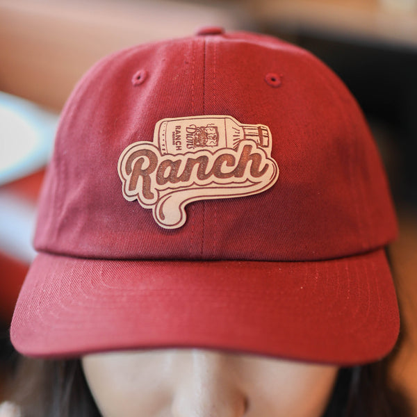 This Dion's Fan Shop Ranch Cap features a patch with a classic design of Dion's Ranch dressing bottle in red.