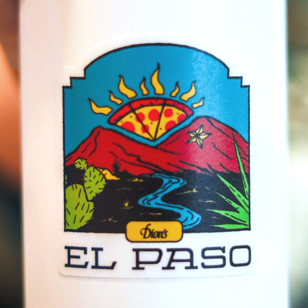 The El Paso Sticker from Dion's Fan Shop features a vibrant pizza slice sun above the Franklin Mountains, with a river, desert plants, and the text "El Paso" and "Dion’s" below the illustration.