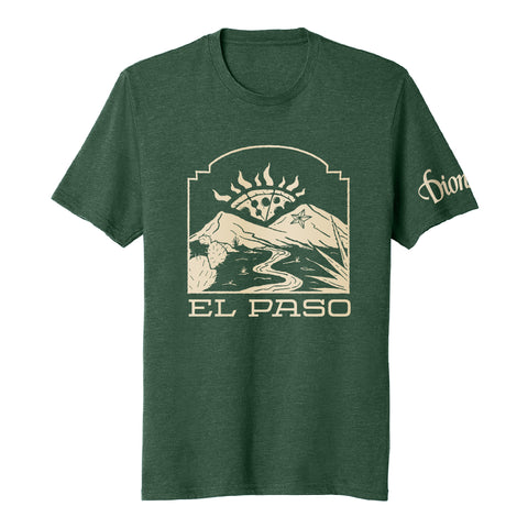 The El Paso Tee by Dion's Fan Shop features a green design with a mountain, sun, and river graphic inspired by the Franklin Mountains. "El Paso" is on the front and "Dion" appears on the sleeve for a special detail.