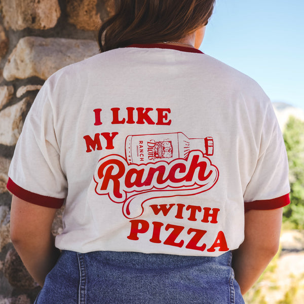 Show off your love for ranch pizza with Dion's Fan Shop's Retro Ranch Tee, featuring bold "I like my ranch with pizza" lettering and retro red trim—perfect for adding vintage vibes to any look.