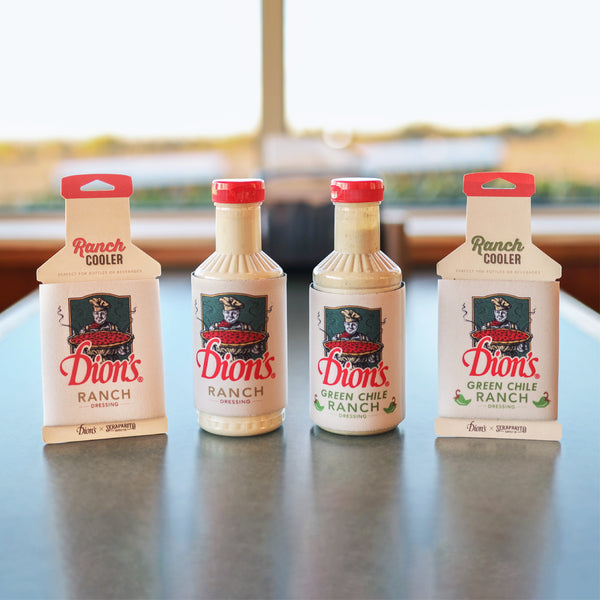 Four bottles of Dion's X Seraparito Green Chile Ranch Cooler from Dion's Fan Shop, with two original and two green chile varieties, stand upright on a counter—ideal for bold snacks or as a spicy ranch dip.