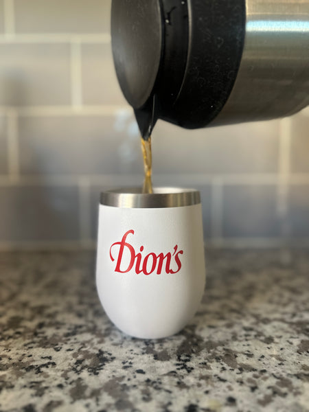 A Dion's Tumbler with the word Dion's Fan Shop on it, perfect for on-the-go sipping.