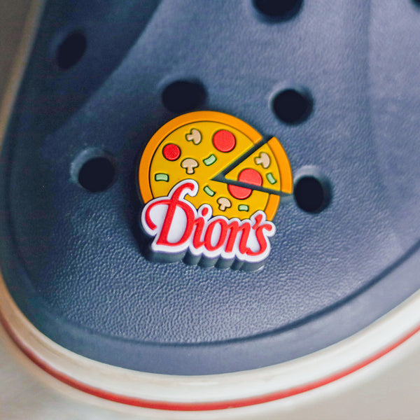 Elevate your footwear game with these blue crocs adorned with a Pizza Shoe Charm from Dion's Fan Shop.
